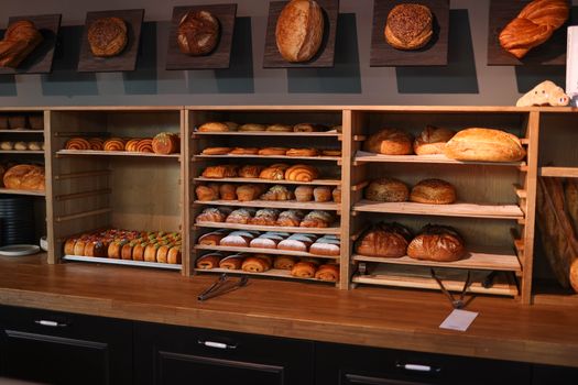 A variety of freshly baked artisan breads and pastries displayed in a bakery.