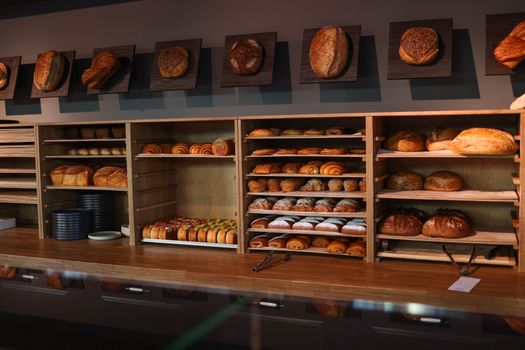 A display of freshly baked bread and pastries in a cozy artisan bakery interior.
