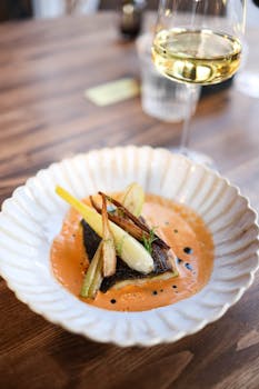 Delicious gourmet fish dish served with artisan sauce, paired with white wine.