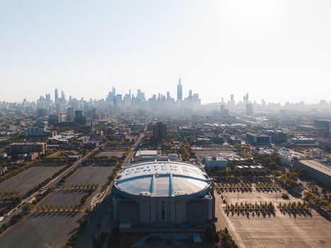 A stunning aerial view of the United Center and Chicago skyline on a bright day.