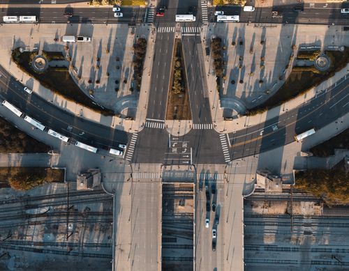 Free Aerial perspective of a busy city intersection with vehicles and trams. Stock Photo
