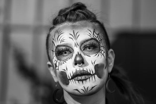 Black and white portrait of a woman with traditional Catrina makeup celebrating Mexican culture in Mexico City.