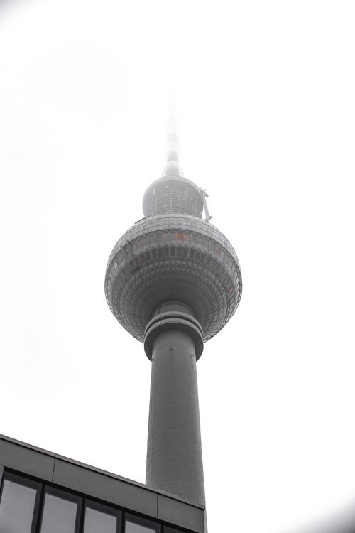 Free Iconic Berlin TV Tower shrouded in mist creates a dramatic urban landscape photo. Stock Photo