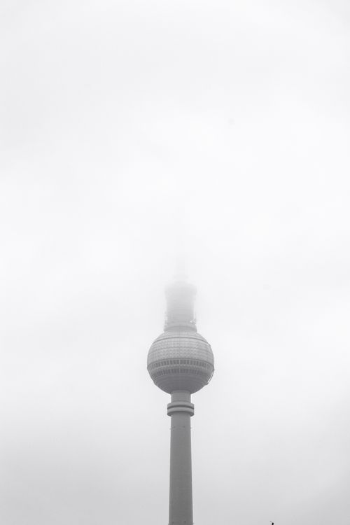 Free A foggy shot of the Berlin TV Tower disappearing into the mist. Captivating urban skyline shot. Stock Photo