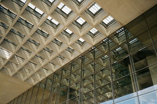 Geometric skylight with glass reflection showcasing modern architectural design.