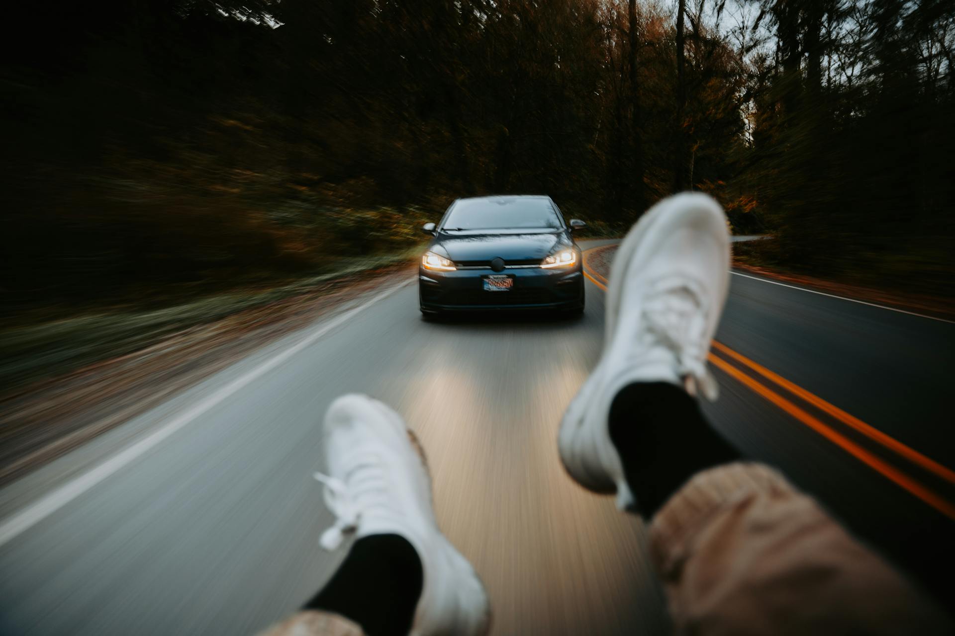 Exciting point-of-view shot showing a car following on a winding road, capturing the thrill of the drive.