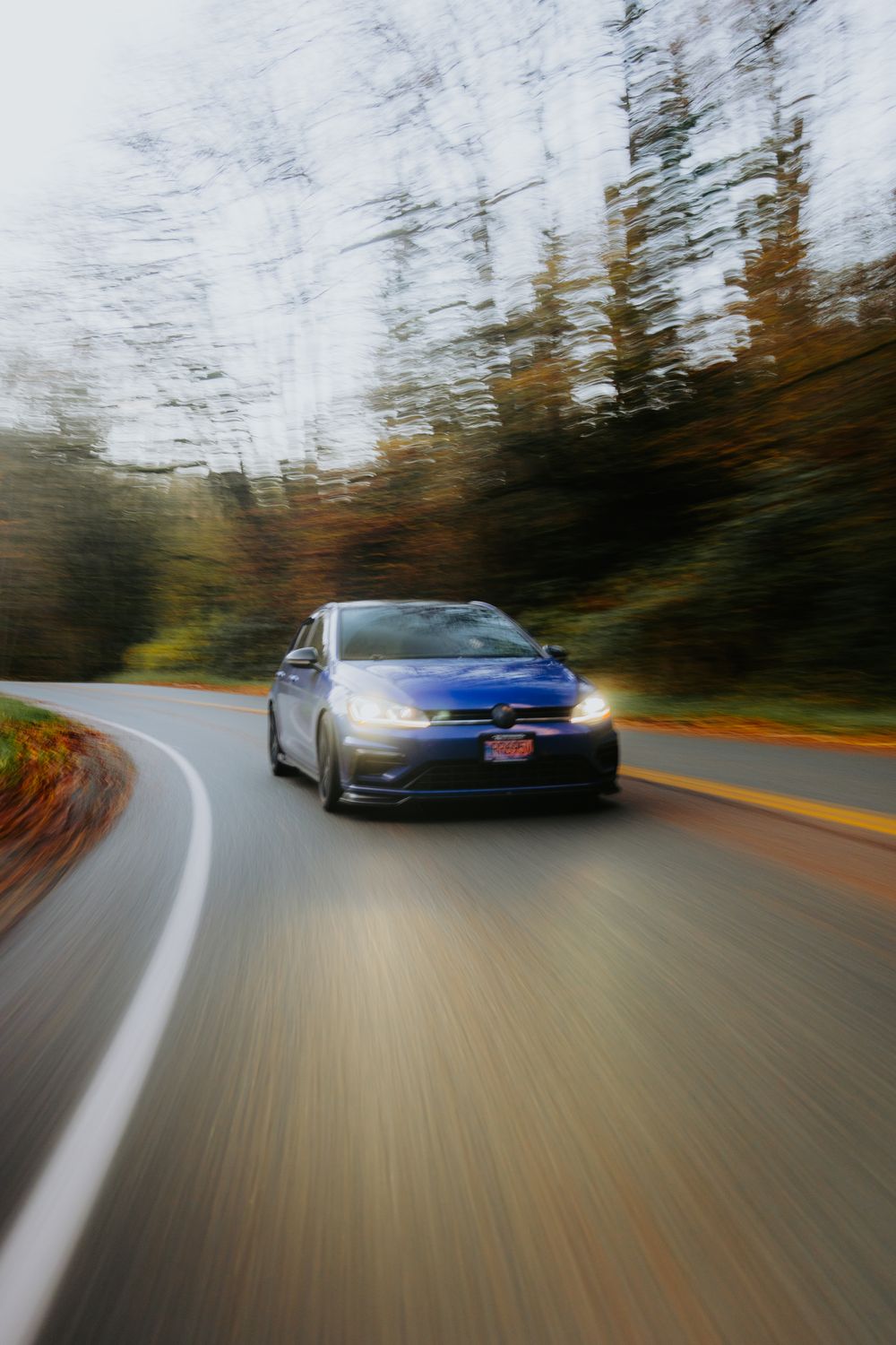 Dynamic Car on Curved Road in Forest · Free Stock Photo