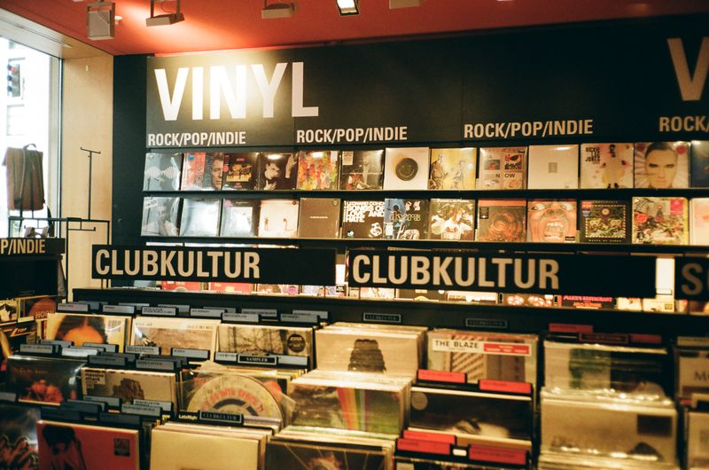 Genre signage across the vinyl racks of a record shop