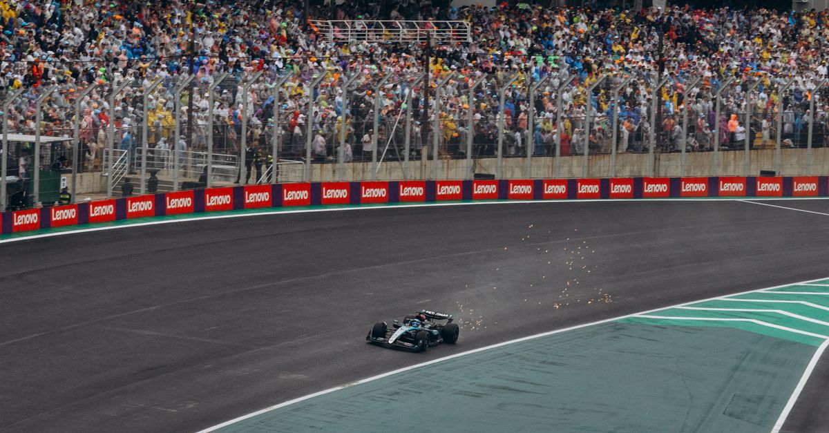 High-adrenaline moment captured during a Formula 1 race with a packed audience.