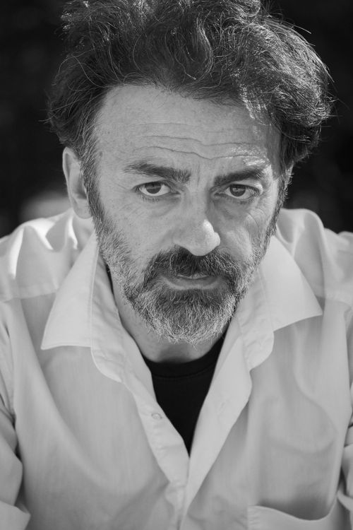 Free Striking black and white portrait of a contemplative man with expressive eyes, in a white shirt. Stock Photo