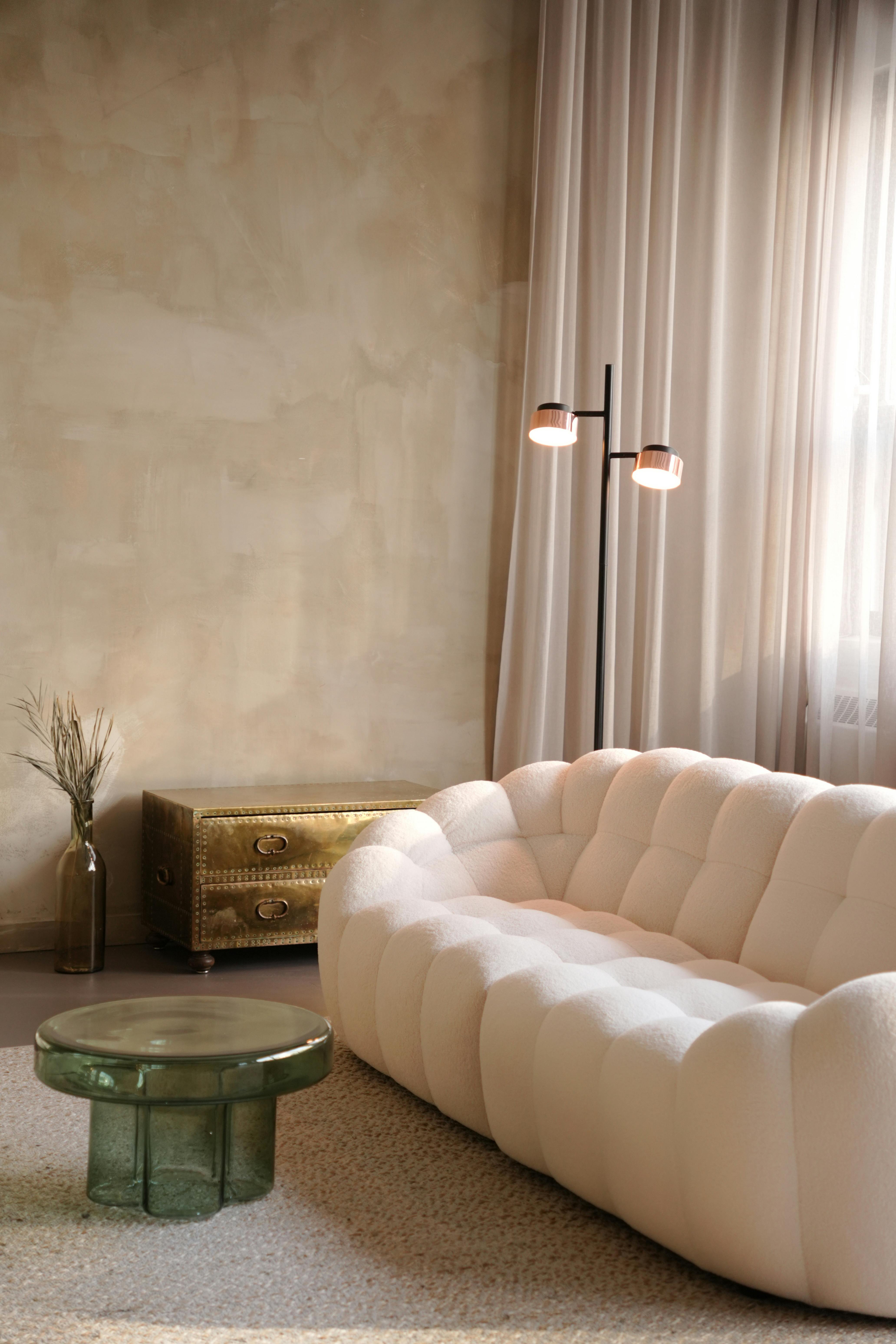 A cozy Japandi-style living room featuring a cloud couch, textured walls, and minimalist decor.