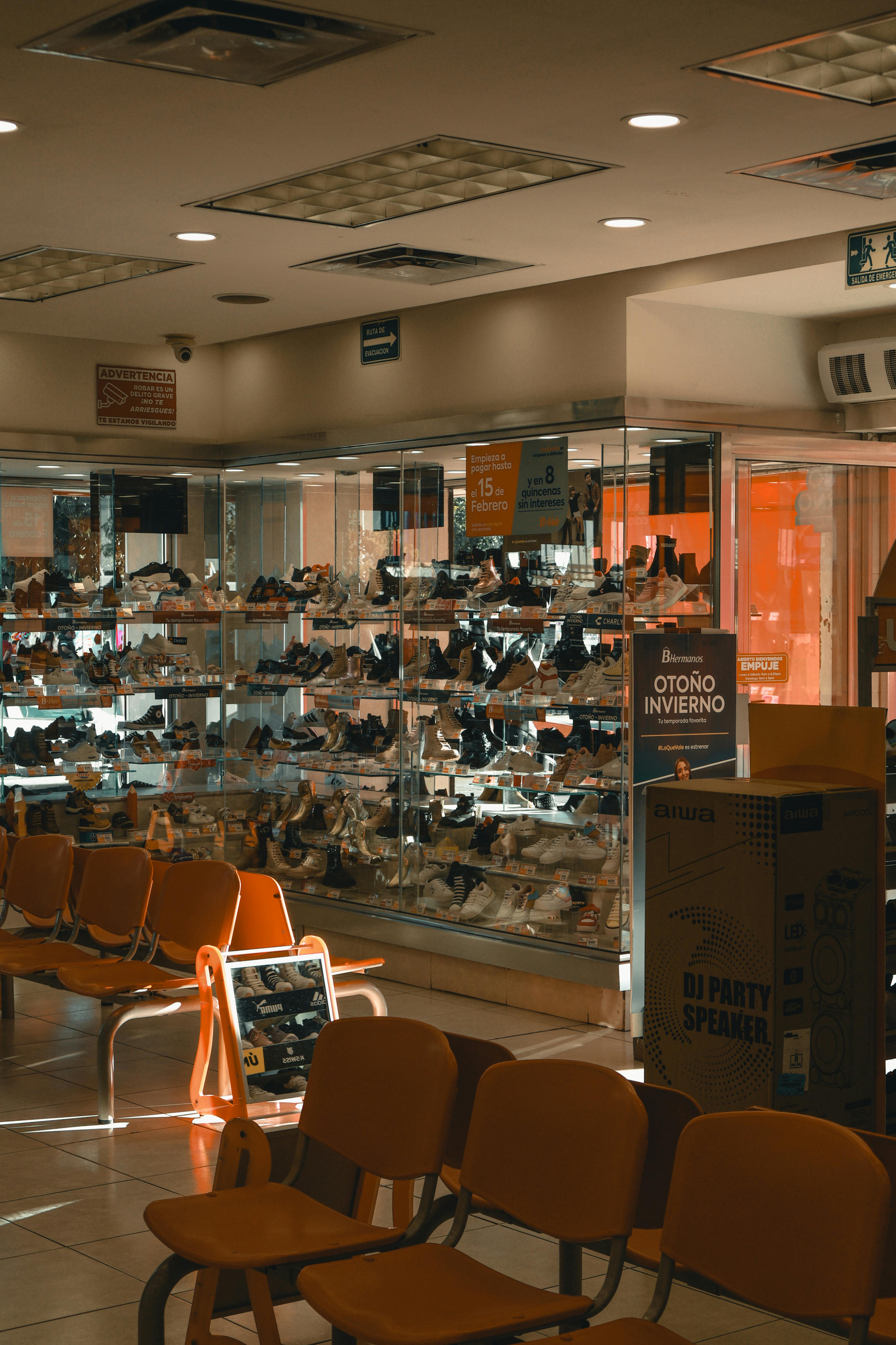 Browse a shoe store in warm light ambiance highlighting modern interior design with displays.