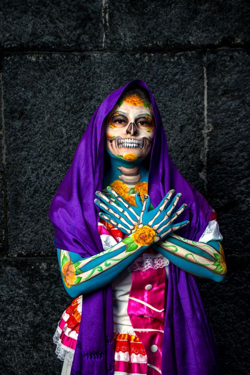 Free Colorful Day of the Dead makeup with flower design, purple shawl. Stock Photo