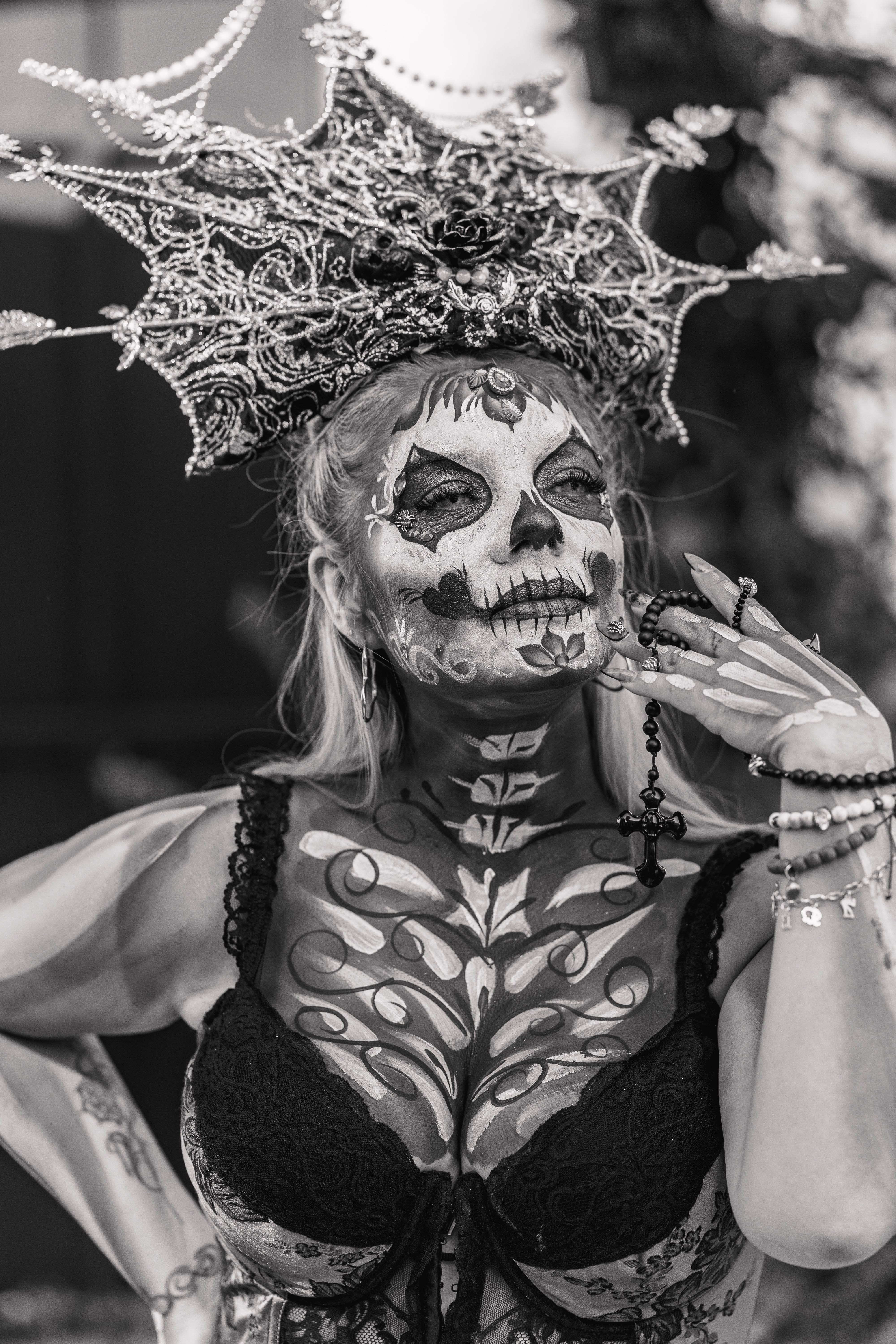 An elegant portrayal of Catrina with skeletal makeup and elaborate headdress in Mexico City.