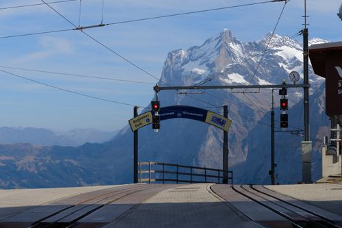 Free Scenic view of train station with Swiss Alps in the background. Perfect for travel enthusiasts. Stock Photo