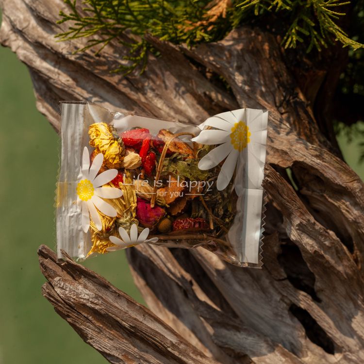 Herbal Tea Blend in Floral Packaging Outdoors · Free Stock Photo