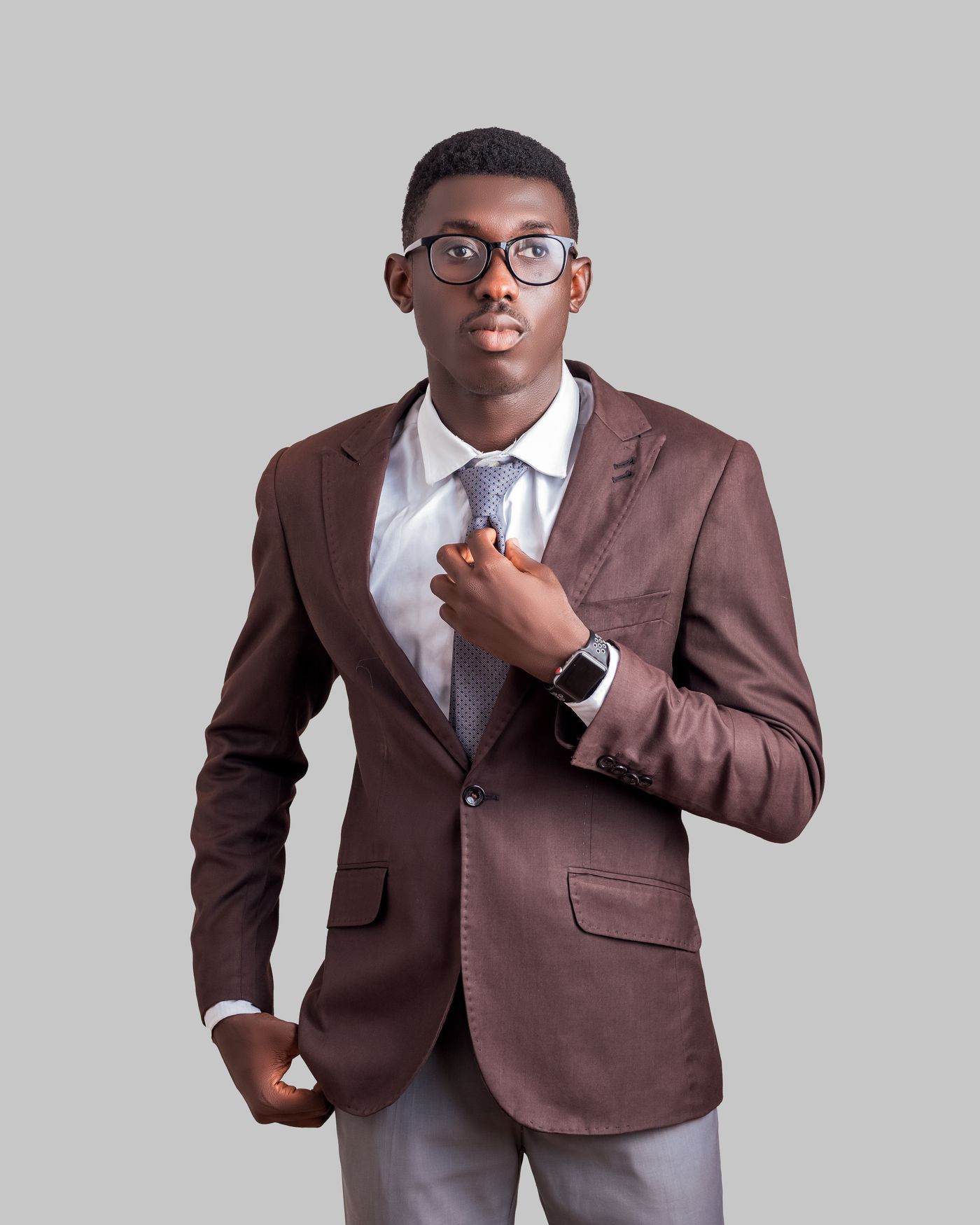 A white shirt and brown jacket, photographed in Accra.
