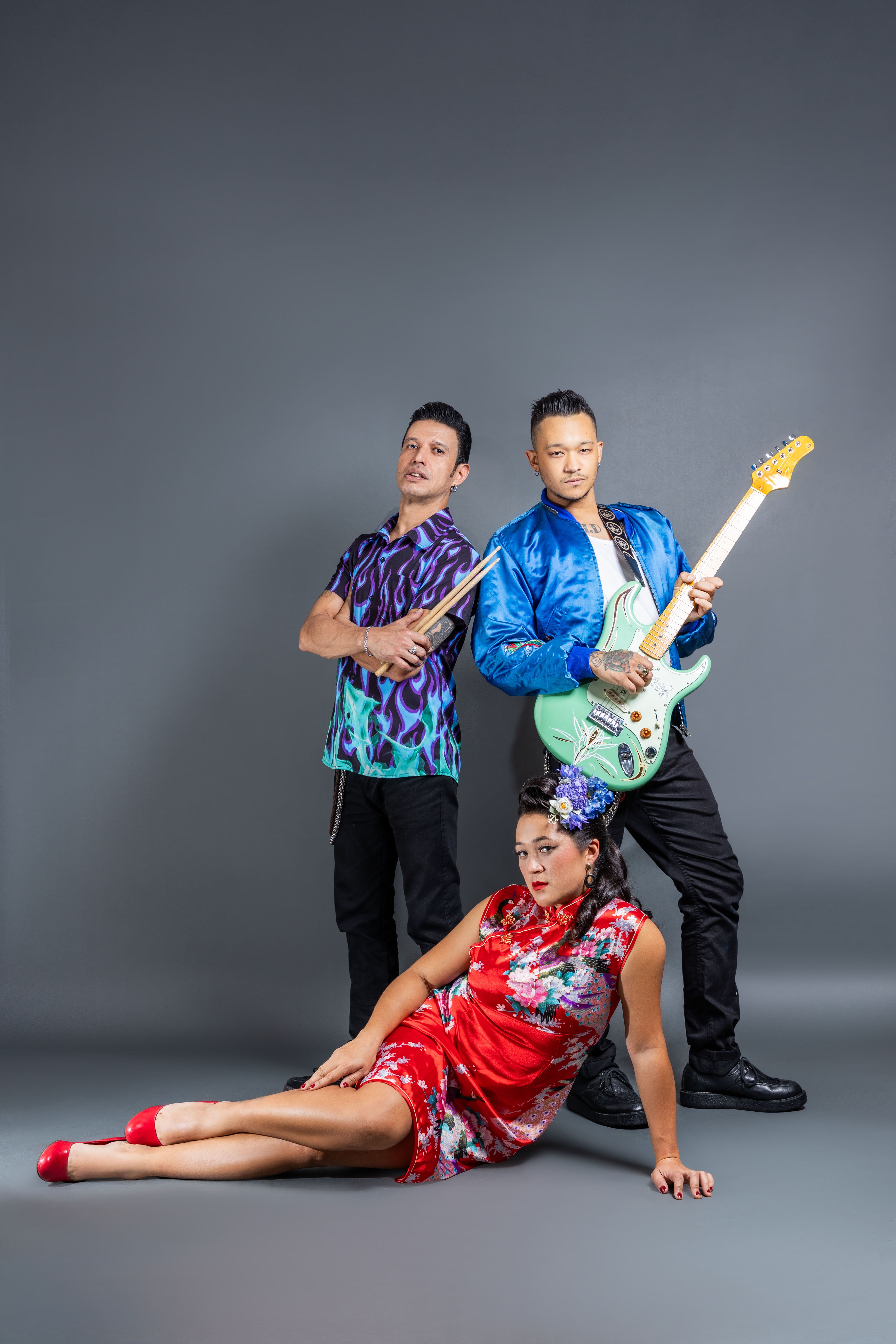 Energetic band portrait featuring musicians with vibrant instruments and stylish attire.