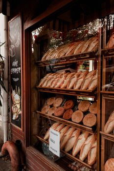 Artisan breads displayed in a charming bakery storefront.