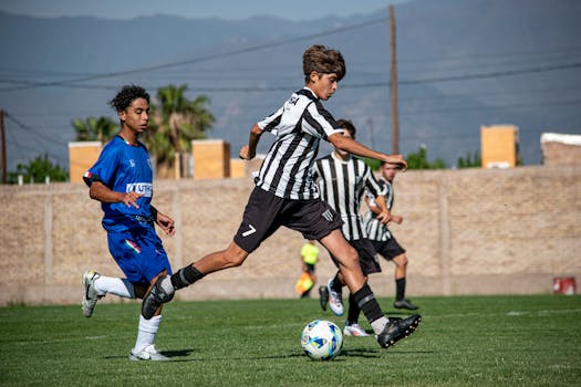 Energetic teens in action during a soccer match on a sunny day.