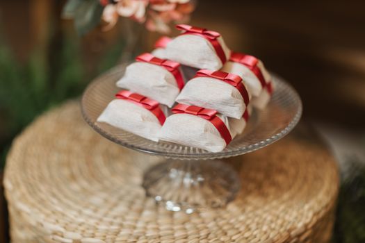 Chic bonbons wrapped with red ribbons on display, perfect for events or presents.