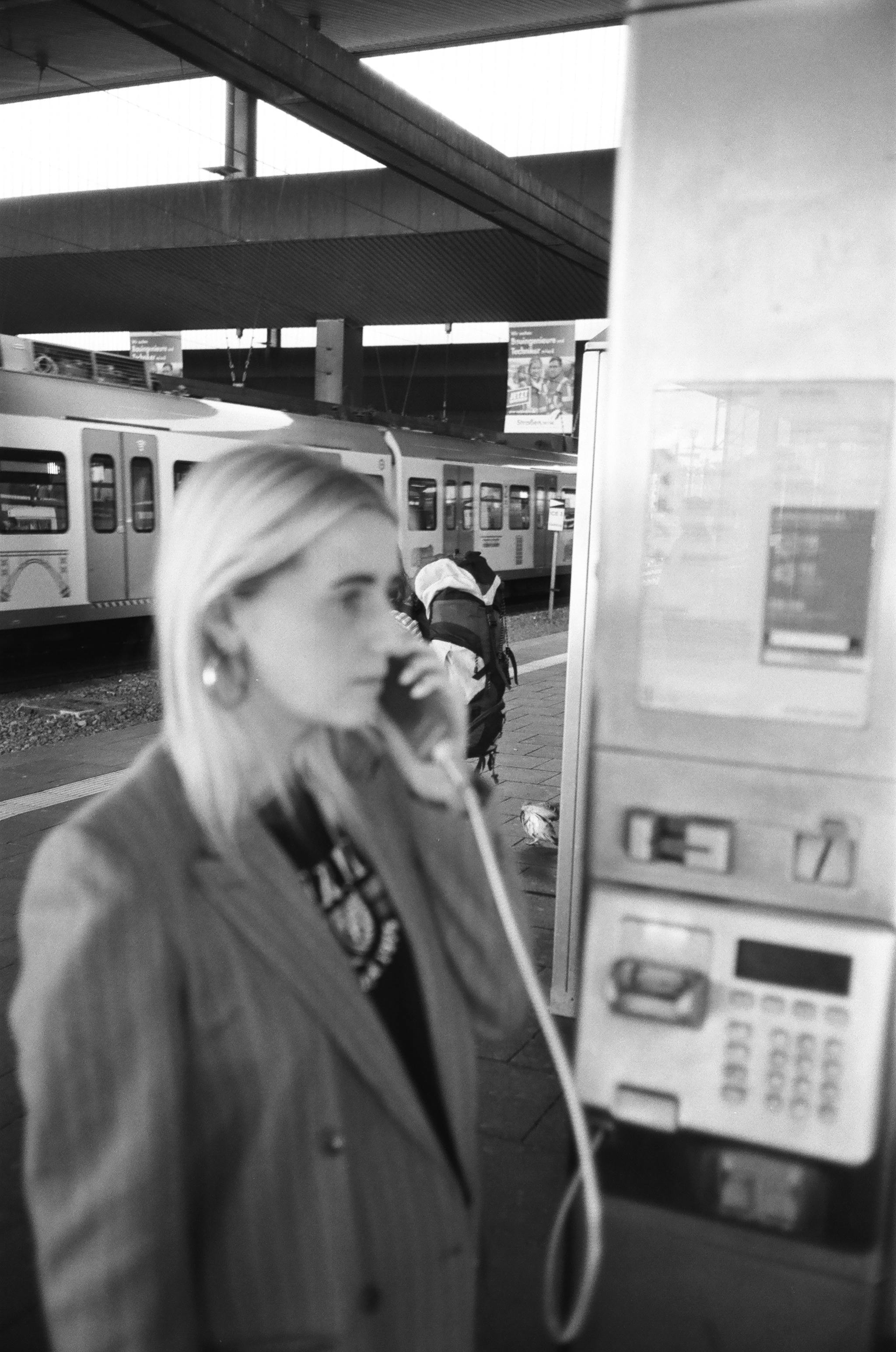 monochrome photo of woman talking on phone