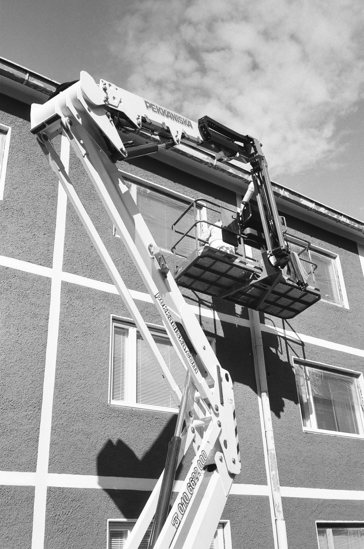 Gray utility bucket truck in field conditions