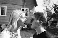 Grayscale Photography Woman Eating Hotdog Outdoors