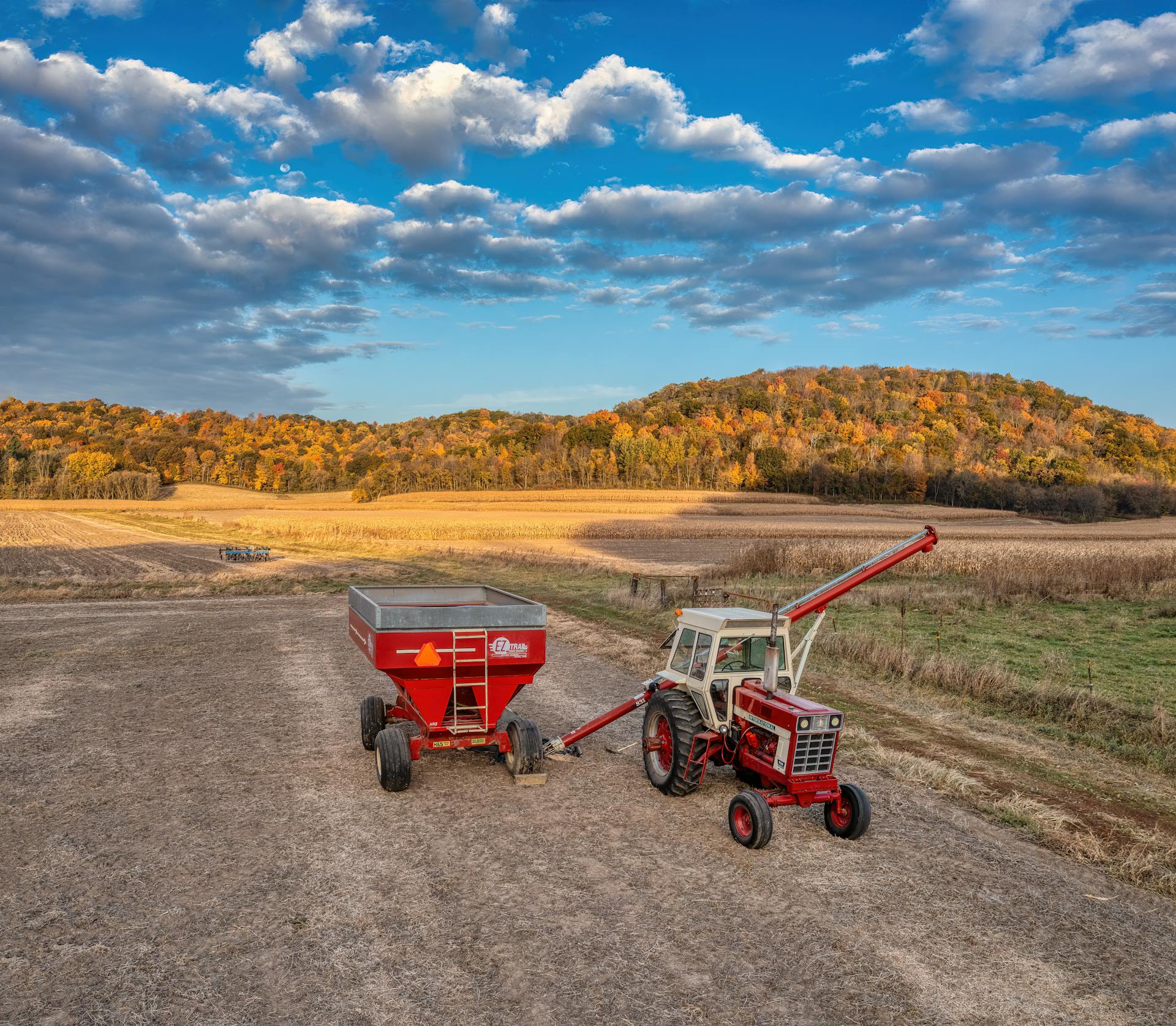 A vintage tractor and trailer on a farm in Nelson, Wisconsin during fall.