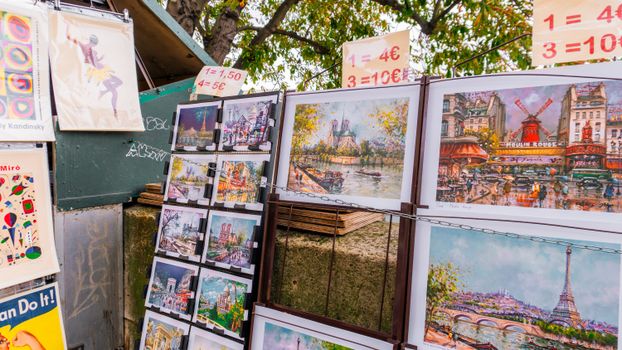 Colorful street art and paintings displayed in Paris, showcasing famous landmarks.