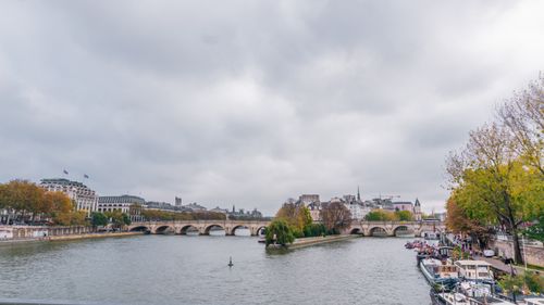 Free Beautiful view of the Seine River in Paris showcasing iconic architecture and autumn foliage. Stock Photo