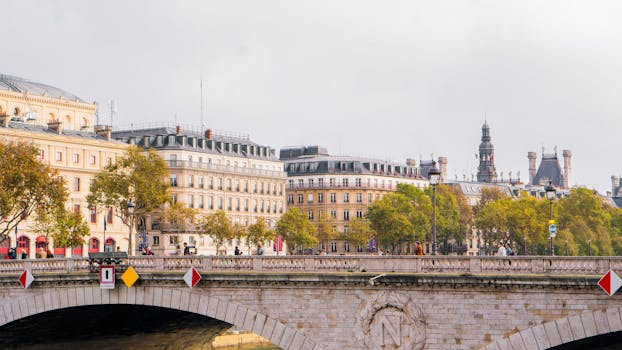 Charming view of Parisian buildings along the Seine River with autumn foliage.