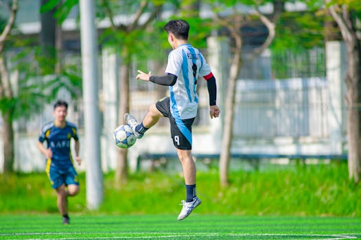 Footballers on the field showcasing skills during a vibrant soccer match in Hanoi.