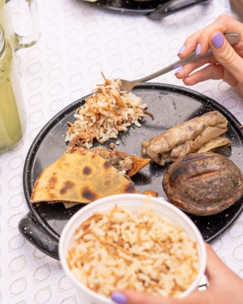 Free A delicious spread of Lebanese cuisine featuring rice, pita, and stuffed vegetables on a tabletop. Stock Photo