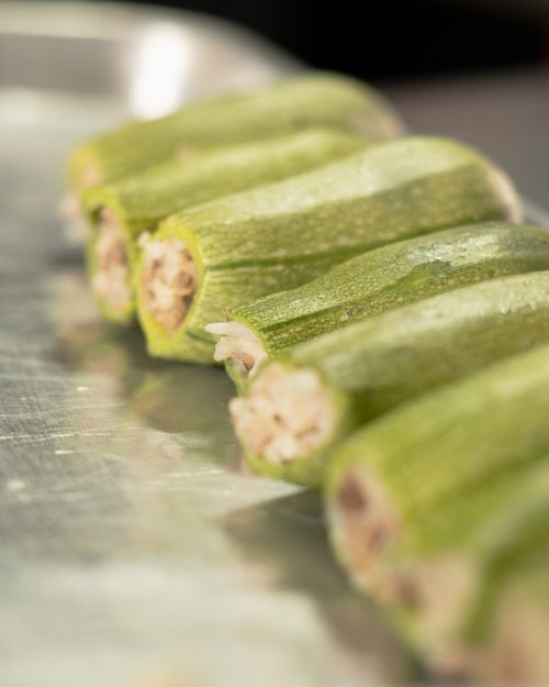 Free Close-up of fresh stuffed zucchinis on a stainless steel tray, perfect for culinary presentations. Stock Photo