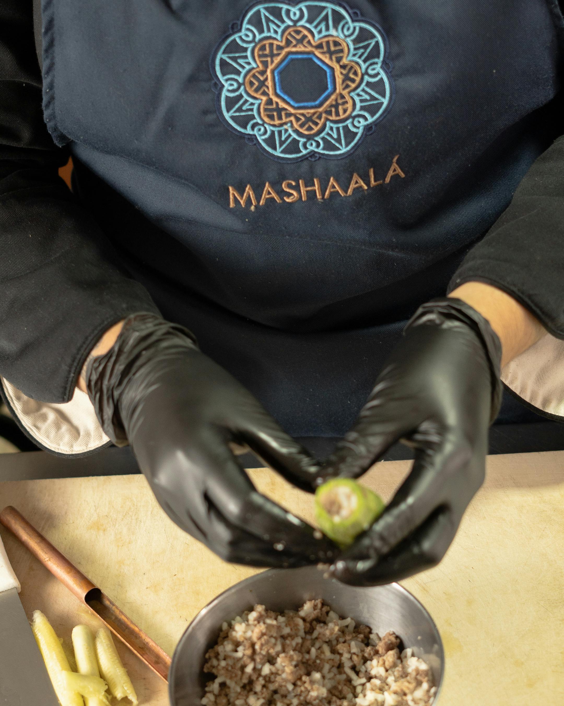 Chef in Santiago de Querétaro prepares Lebanese stuffed vegetables, showcasing regional cuisine.