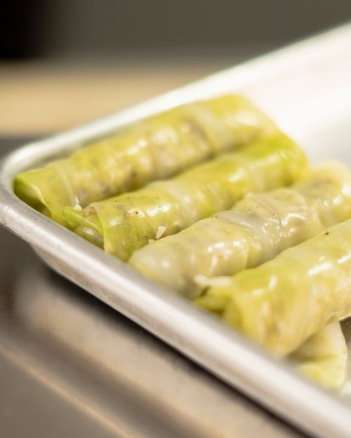 Free Delicious homemade stuffed cabbage rolls presented on a cooking tray in Santiago de Querétaro. Stock Photo