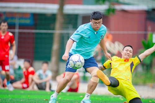 Free Dynamic action shot of a soccer tackle during a match in Hanoi, Vietnam. Stock Photo