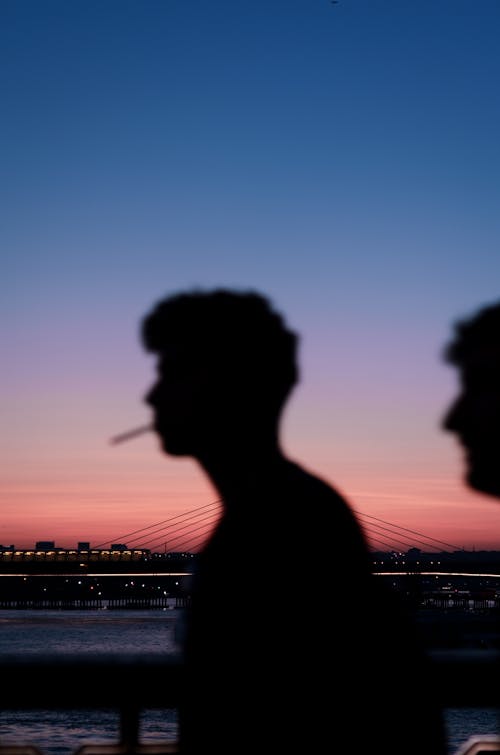 Silhouette Photography of A Man With A Cigarette On His Mouth