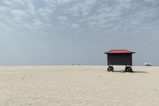 A peaceful scene of an empty beach with a solitary cart in Alappuzha, Kerala, India.