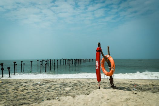 Lifeguard equipment on the sandy shores of Alappuzha Beach, Kerala, India, under a clear sky.