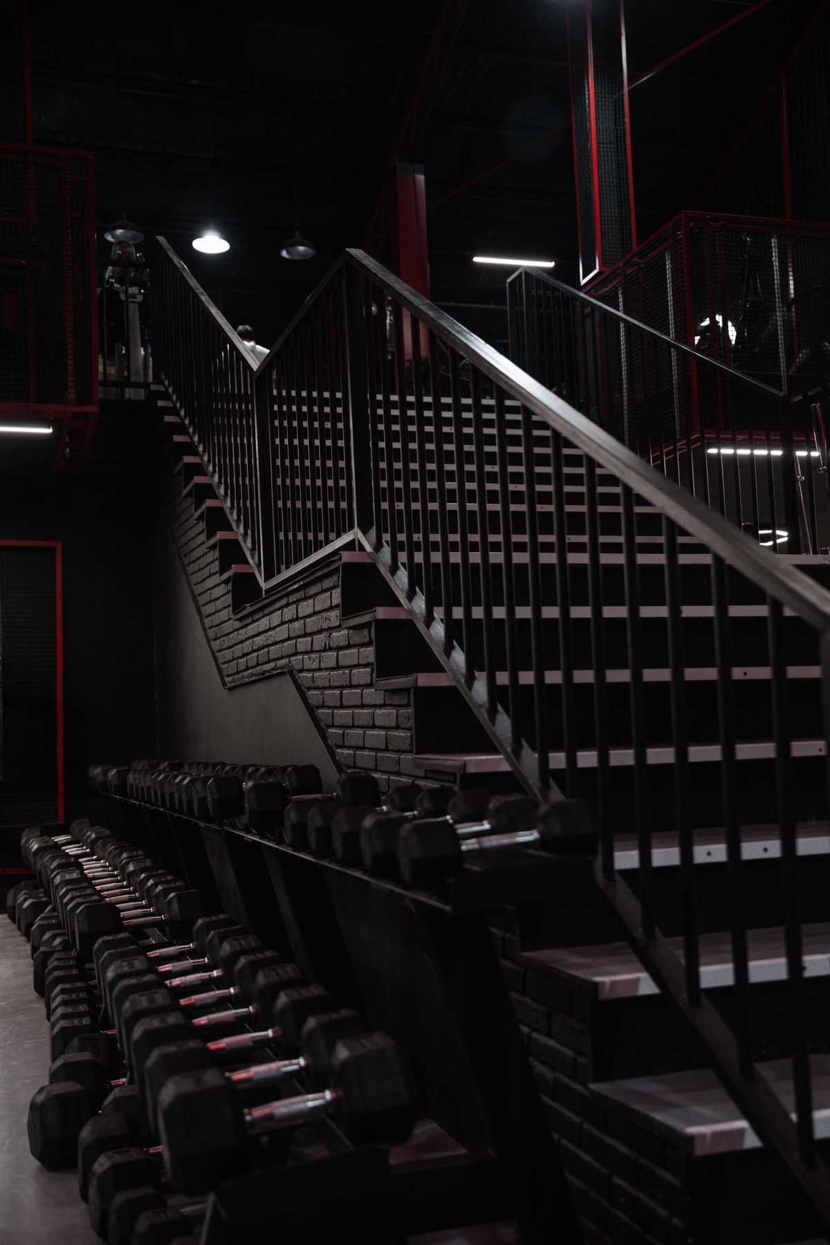 A gym interior with a rack of dumbbells, where the muscle-protecting work happens