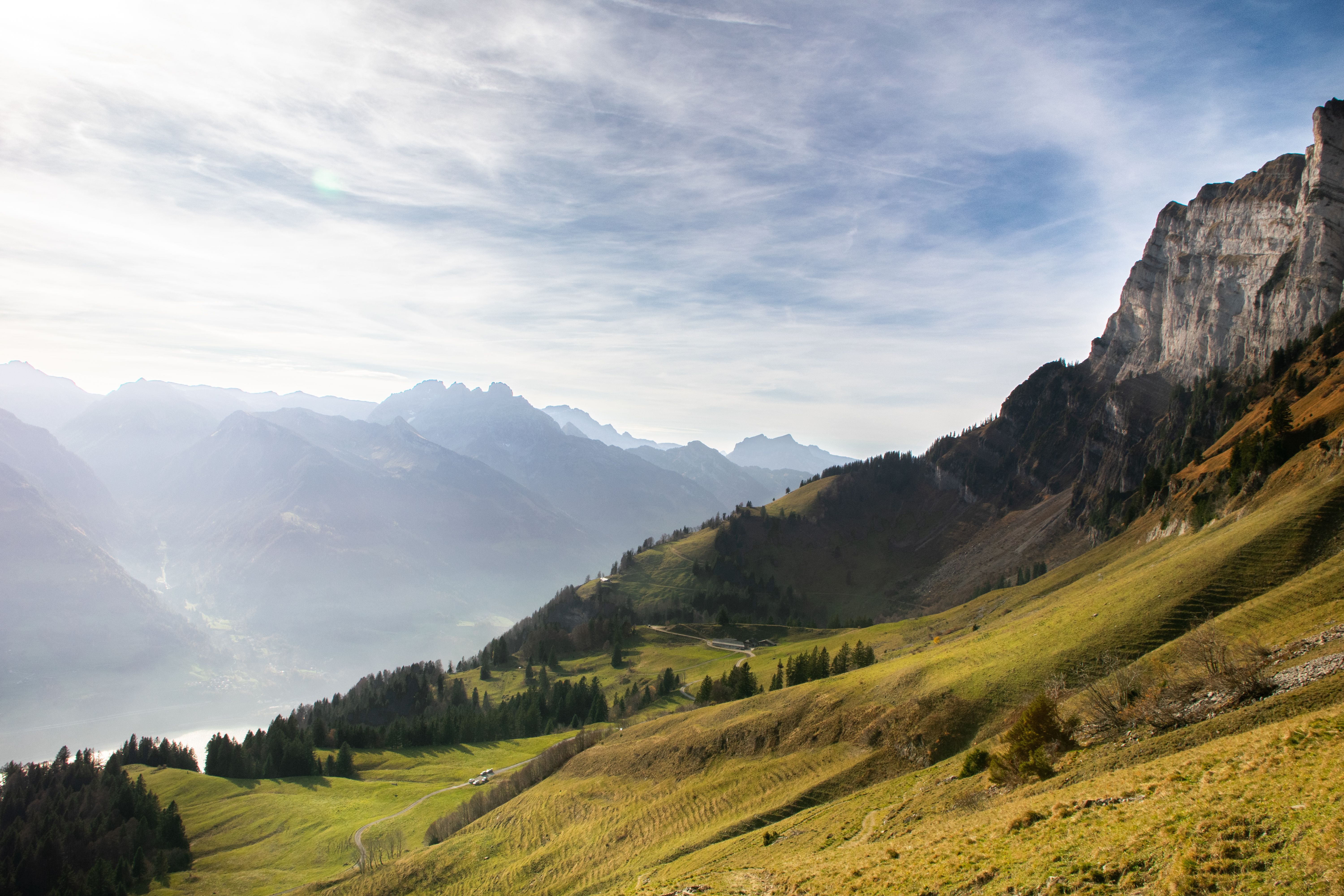 Scenic Mountain View with People Relaxing on Bench · Free Stock Photo