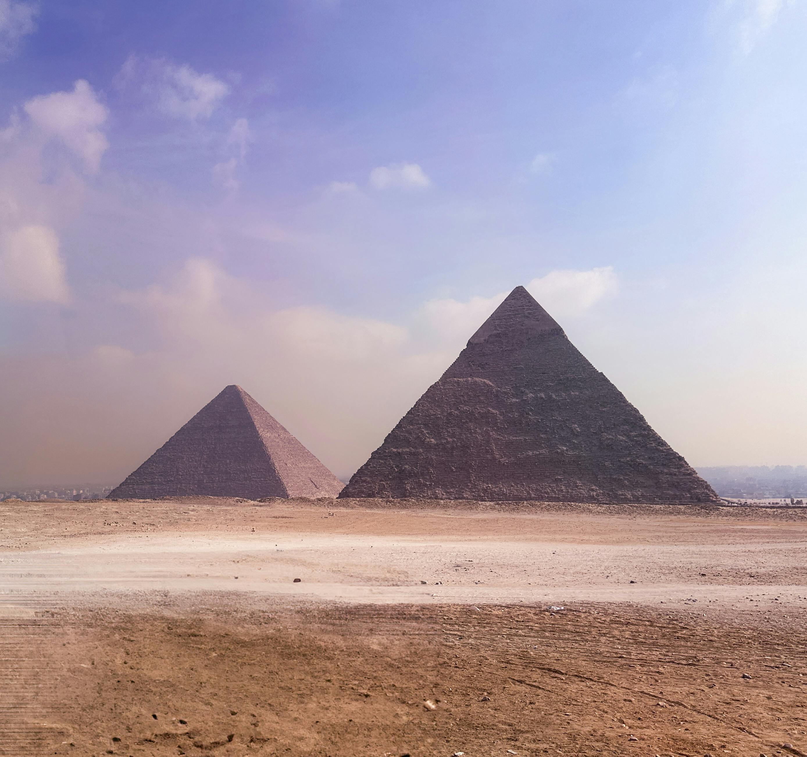 Iconic image of the Great Pyramids of Giza under a clear sky, capturing timeless beauty.