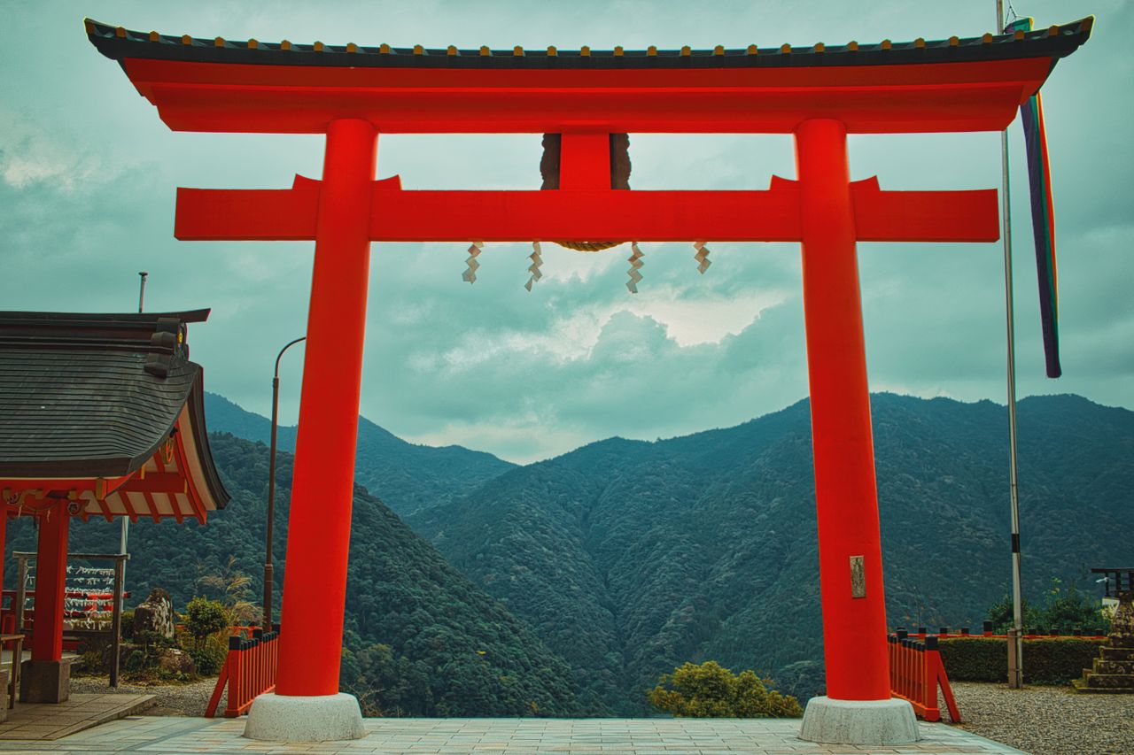 a striking red torii gate in nachikatsuura wakayama japan against a mo