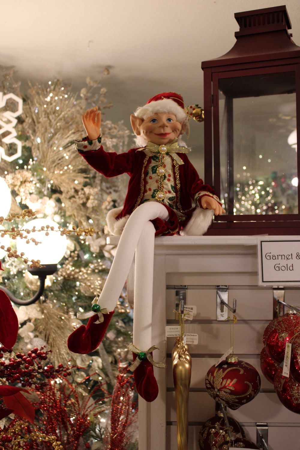 Elf Display Festive Elf Sitting on Holiday Shelf Display · Free Stock Photo