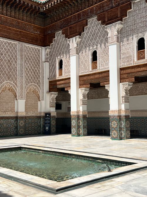 Free Beautiful Moroccan courtyard with traditional architecture and intricate tilework. Stock Photo