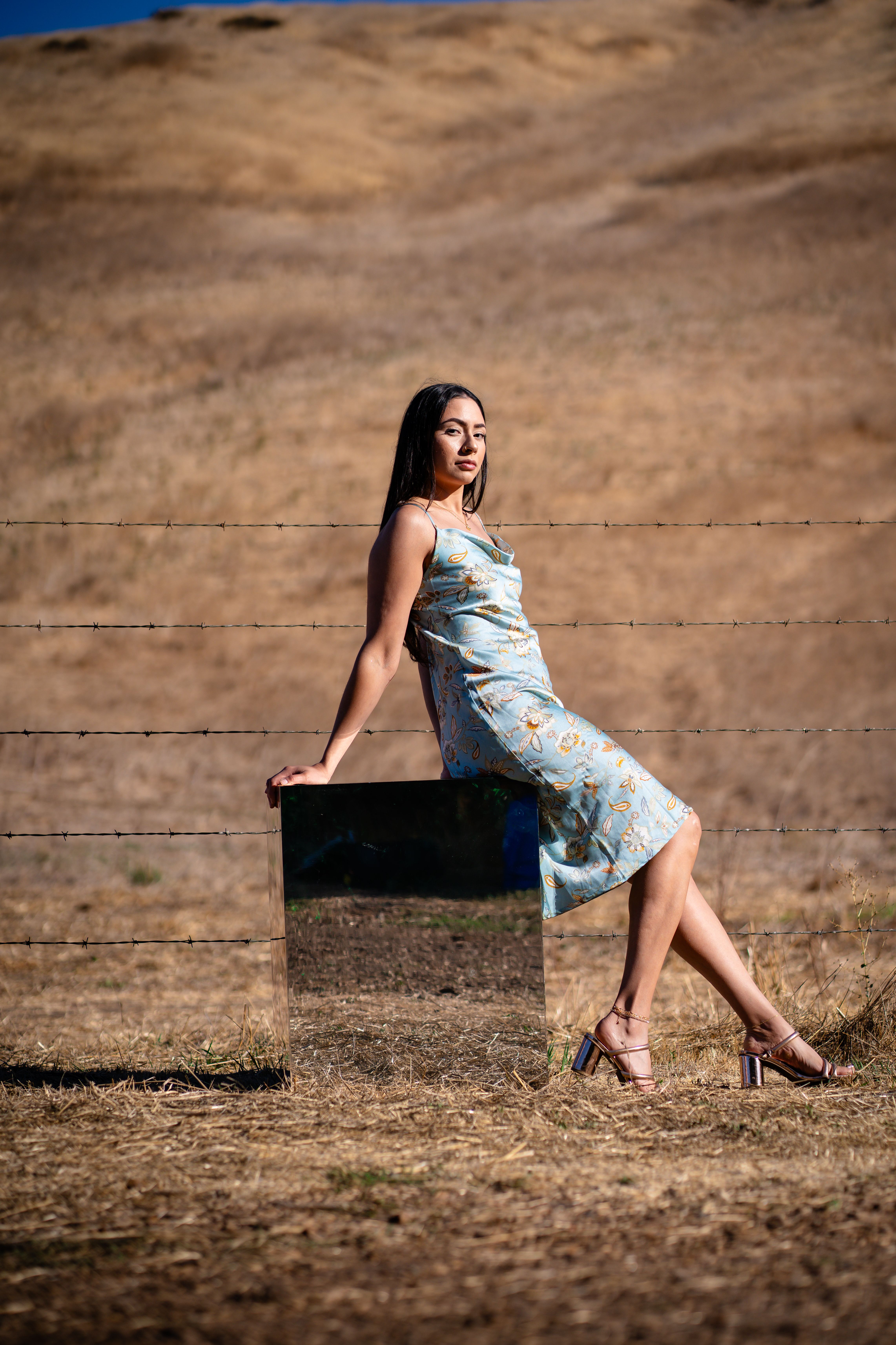 Woman in Floral Dress Posing Outdoors · Free Stock Photo