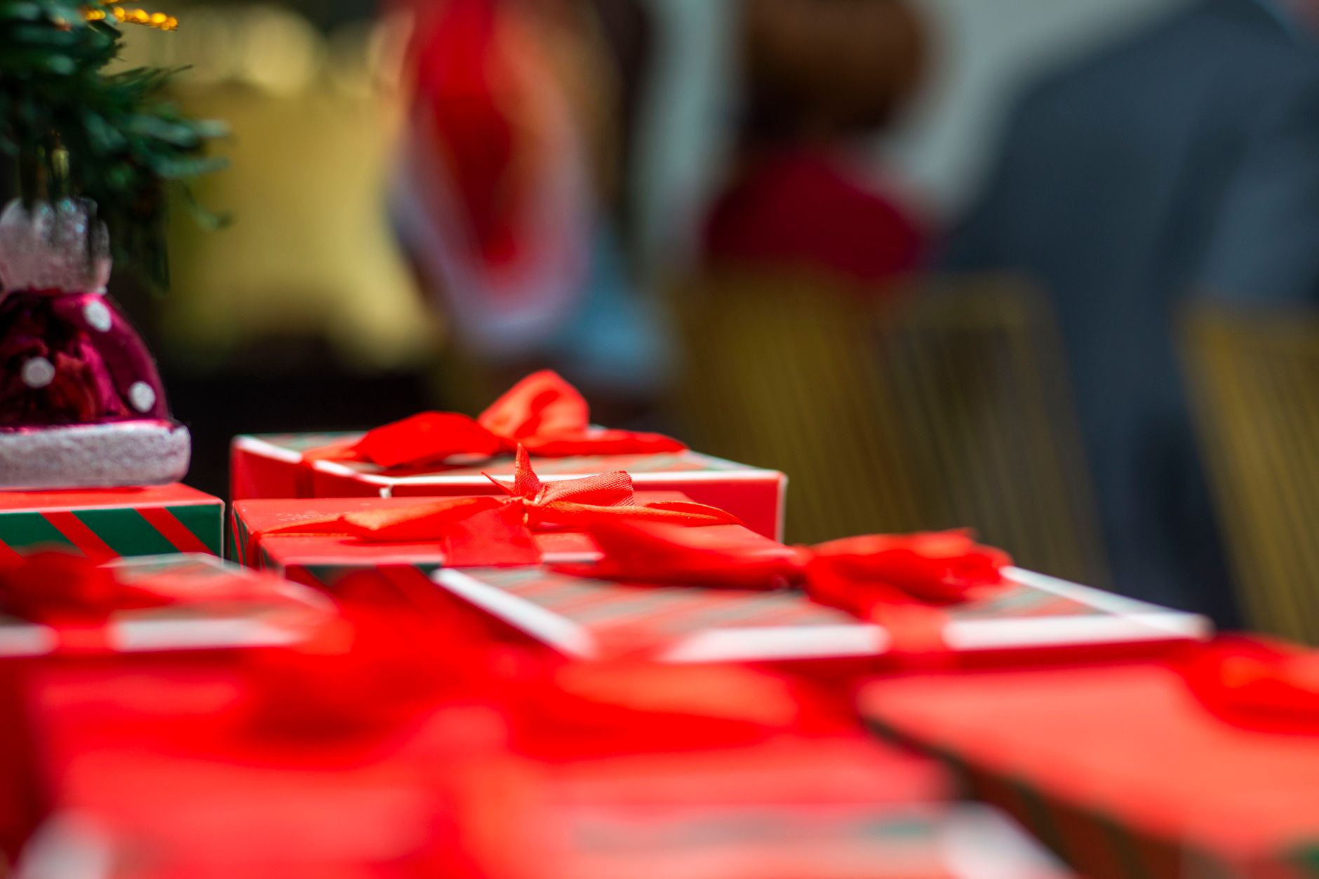 Vibrant red and white Christmas gift boxes with ribbons, capturing the festive holiday atmosphere.