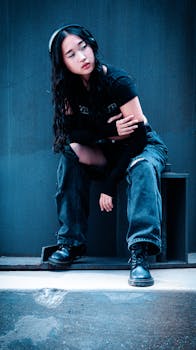 Fashionable woman in urban setting, showcasing modern streetwear style and attitude.